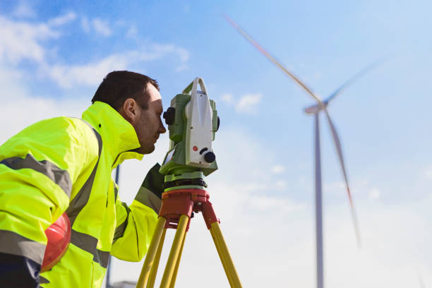 istock Engineer working at wind turbine electricity station looking through Optical Instrument 1098269634