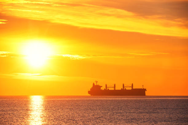 istock Sunrise over the sea with sailing cargo ship. Transportation. Logistics. Shipping. 1098270064