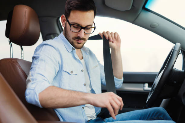 istock Driver fastening his seat belt in car 1098270106