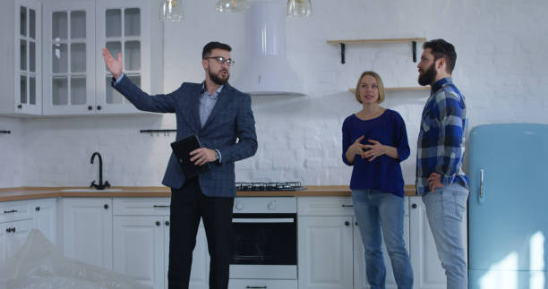 real estate agent showing property to a couple - home inspection imagens e fotografias de stock