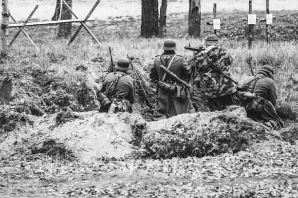 Gomel, Belarus - November 26, 2017: Machine gun crew of German Wehrmacht soldiers in the form of the World War 2 on a black-and-white photo. Staging the liberation of the city of Gomel from Nazi Germany