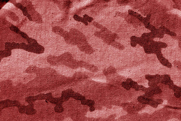 Dirty camouflage cloth in red tone. Abstract background and texture for design abd ideas.