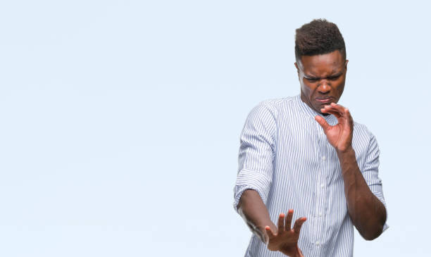 istock Young african american man over isolated background disgusted expression, displeased and fearful doing disgust face because aversion reaction. With hands raised. Annoying concept. 1098280202