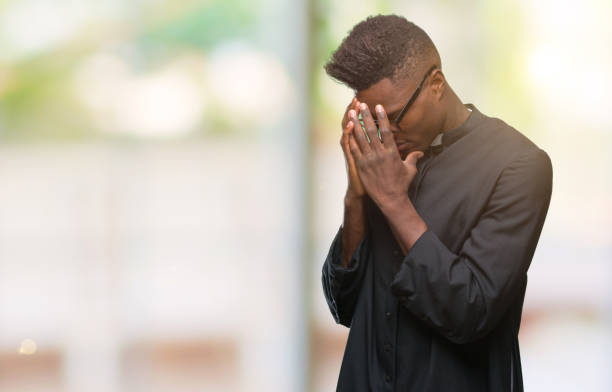 istock Young african american priest man over isolated background with sad expression covering face with hands while crying. Depression concept. 1098283432