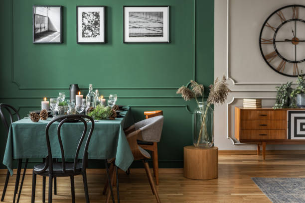 istock Trendy bottle green dining room with table set for christmas dinner 1098283918