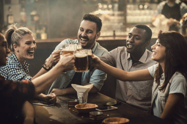 istock Young happy friends having fun while toasting with beer in a pub. 1098285986