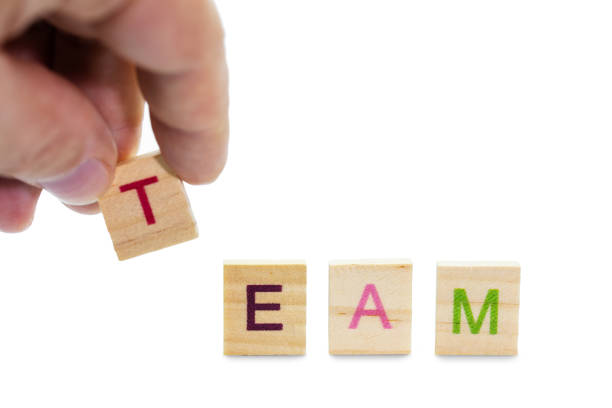 istock Male hand composes word Team of letters 1098287406