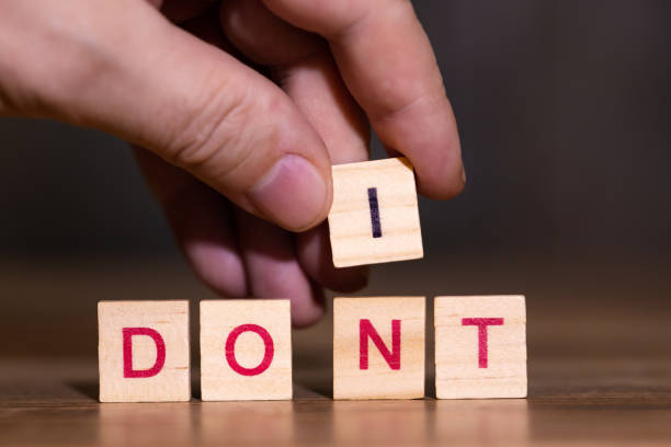 istock Hand exchanges the letter N in the word dont for an I, do it 1098287656