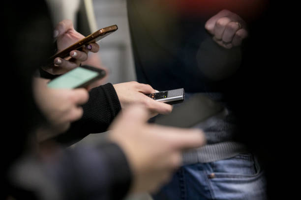 istock Journalist and camera man with microphone and recorder on smartphone application Interviewing businessman, politician 1098288432
