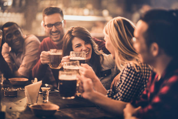 istock Group of young joyful friends having fun while toasting with beer in a pub. 1098289256
