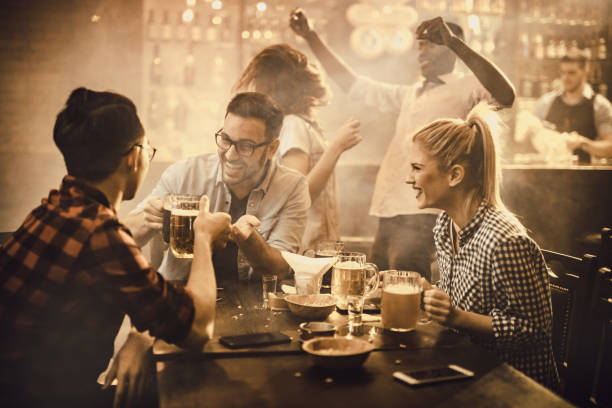 istock Young cheerful friends having fun during the night out in a bar. 1098293352