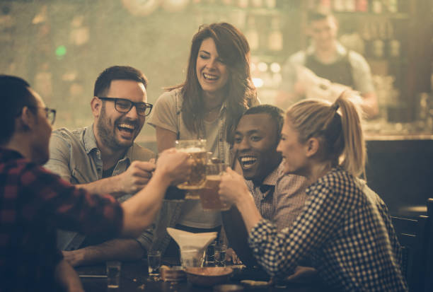 istock Cheerful friends having fun while toasting with beer during their night out in a bar. 1098293544