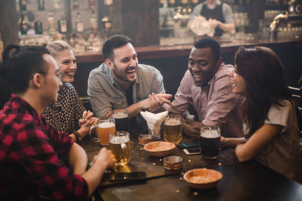 istock Cheerful friends talking during their night out in a pub. 1098293638