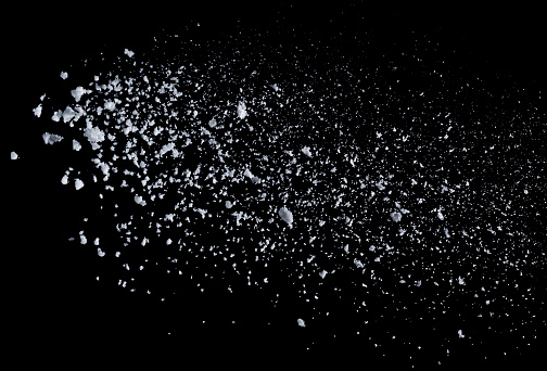 Isolated thrown snow against a black background