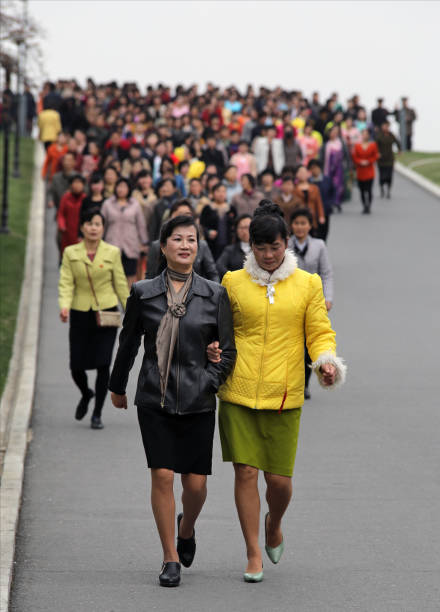 April 13, 2018. Pyongyang, North Korea.\nNorth Korean women show their respects to their leaders by coming to the Great Monument at Mansu Hill with bronze statues of Kim II-Sung and Kim Jong-II.