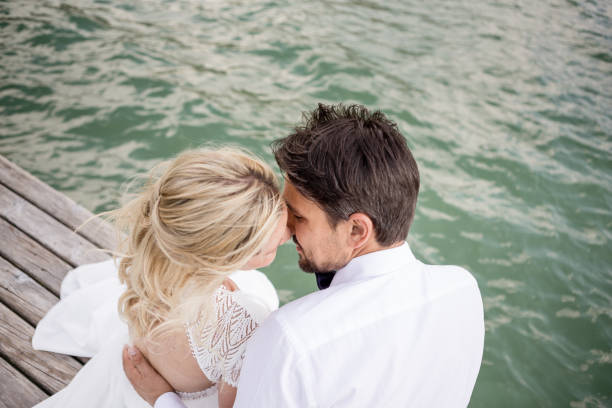 istock Beautyful wedding couple relaxing on footbridge 1098296578