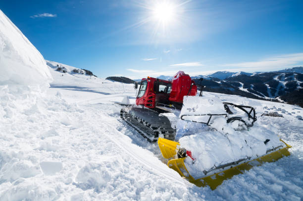 istock Snowcat clearing snow on a ski piste on a sunny day 1098296722