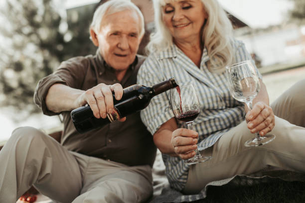 istock Happy beloved couple going to drink wine 1098297108