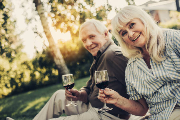 istock Cheerful mature coupe having picnic on lawn 1098297116