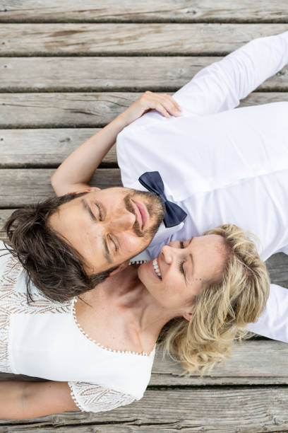 istock Beautyful wedding couple lying on a jetty 1098297130