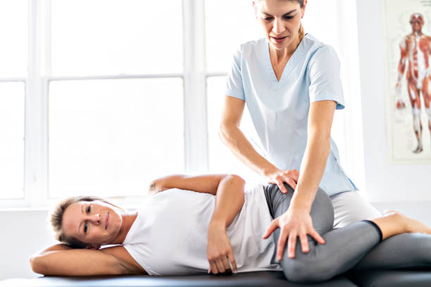 istock A Modern rehabilitation physiotherapy worker with woman client 1098297844