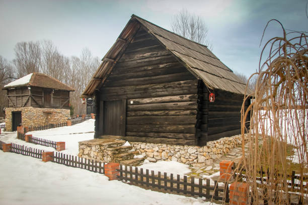 Velika Plana, Serbia - january 18 2019: Snow melting, sunset, ethno village Moravski Konaci, near the Velika Plana in Serbia. It's a reproduction of authentic old Serbian village with own specific architecture. Also, this is a very popular tourist destination.
