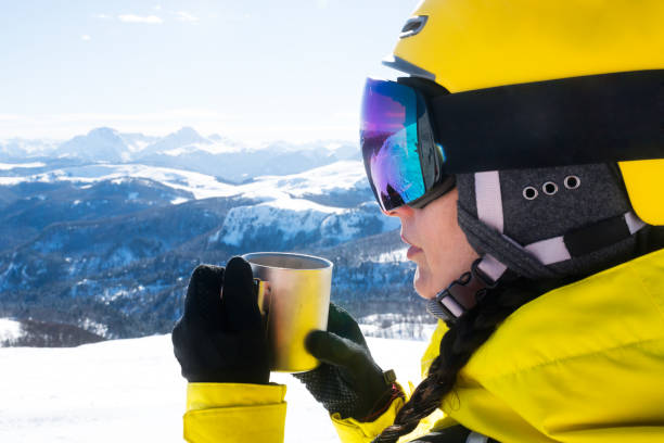 istock A female ski tourer taking a break and enjoying a beautiful view while drinking a hot drink from a cup 1098298100