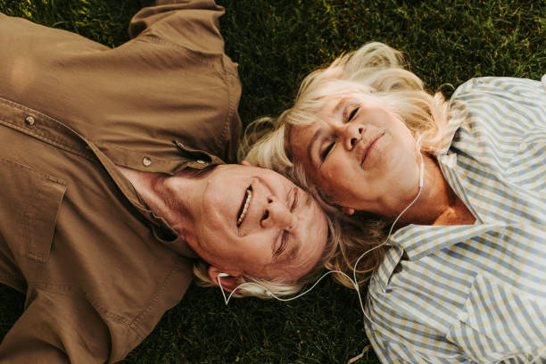istock Joyful elderly twosome enjoying music outdoors with smile 1098300744
