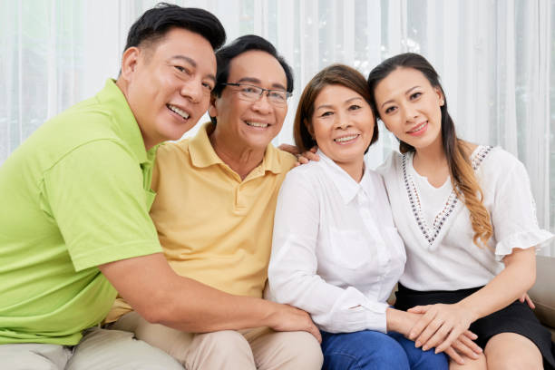 Embracing ethnic people on couch at home