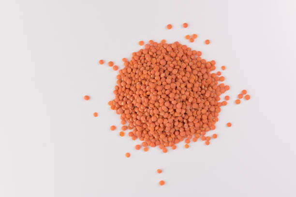 istock pile red lentils isolated on white background, top view 1098313858