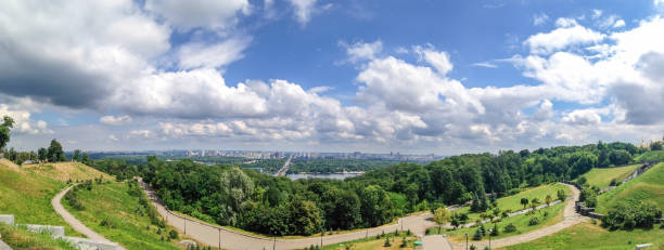 istock Panoramic view from the park area to the trees, grass, cloudy sky, the Dnieper River and the city of Kiev, Ukraine 1098314408