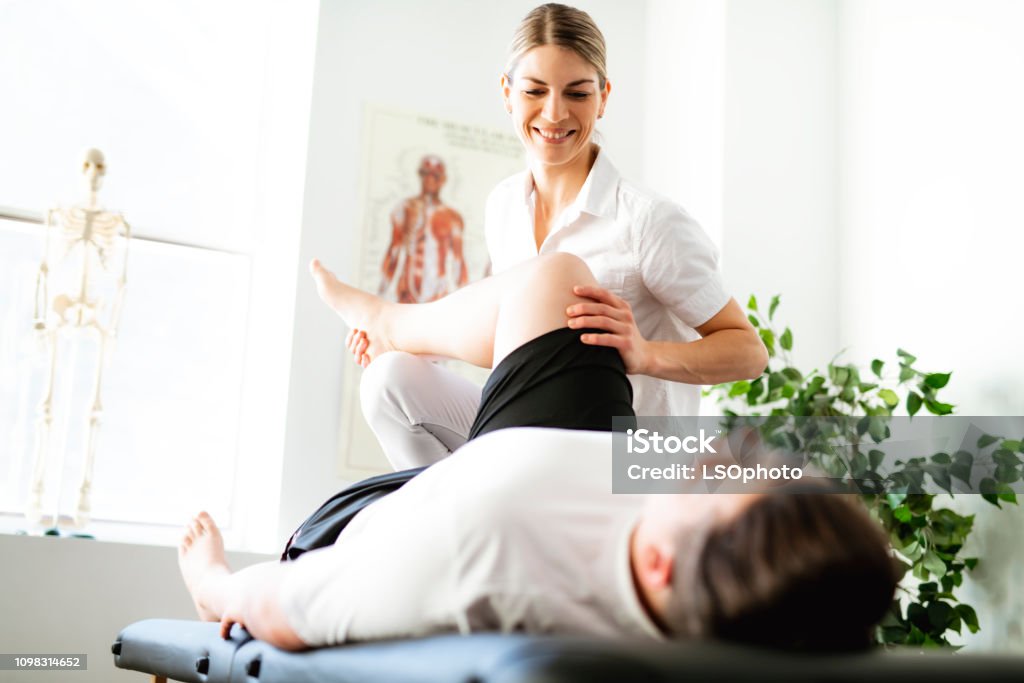 A Modern rehabilitation physiotherapy woman worker with client Modern rehabilitation physiotherapy woman worker with client Physical Therapy Stock Photo