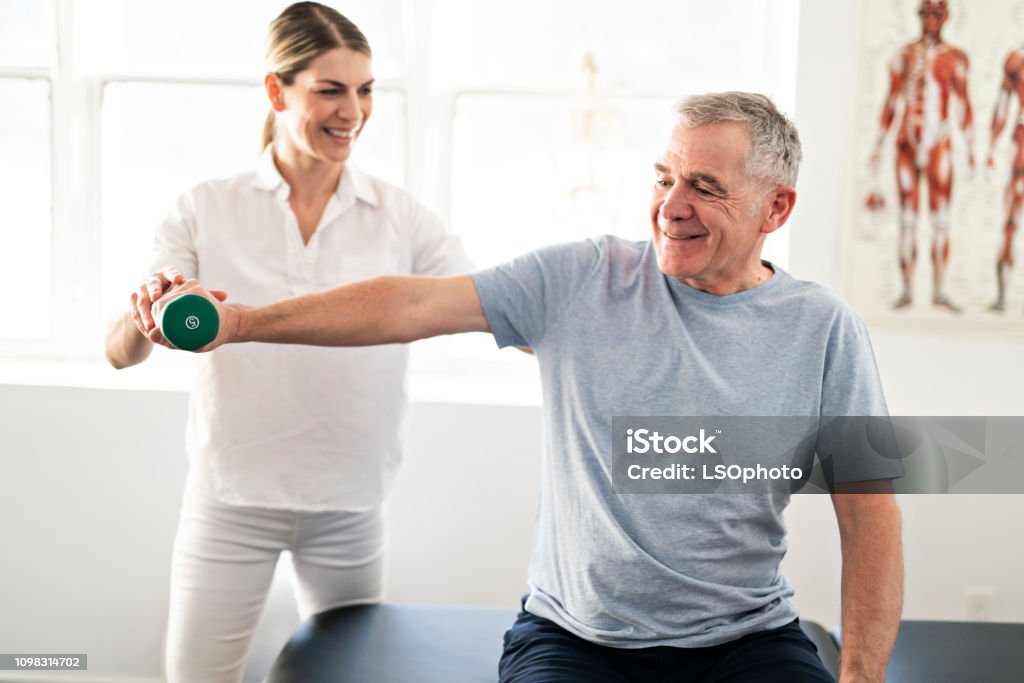 A Modern rehabilitation physiotherapy worker with senior client Modern rehabilitation physiotherapy worker with senior client Physical Therapy Stock Photo
