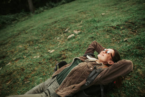 istock Joyful girl lying on back with arms above her head 1098315266