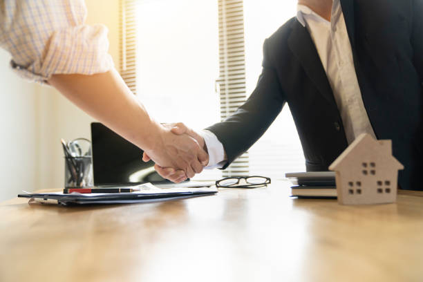 istock Banker business man shaking hands with client and sign contrac document for comfirm corporation or finished loan agreement for house or building property.Document in photo is fake only for stock phoot. 1098317648