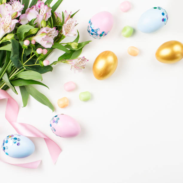 istock Festive Easter background with decorated eggs, flowers, candy and ribbons in pastel colors on white. Copy space 1098330820