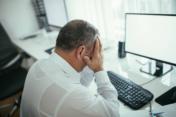 istock Frustrated businessman head in hands 1098331344