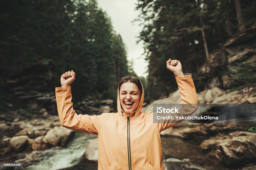 Waist up of a jubilant young woman enjoying forest environment Overjoyed delighted woman expressing gladness while resting in the forest Adult Stock Photo
