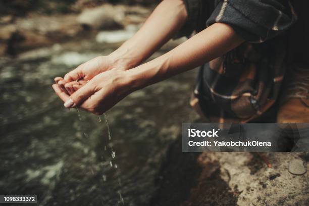 Close Up Of Female Hands With Fresh Water From The River Stock Photo - Download Image Now