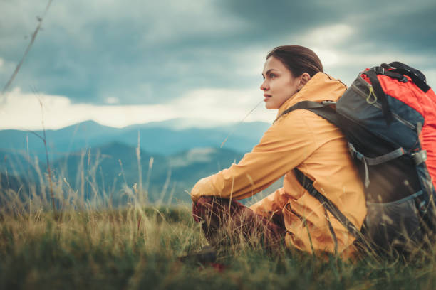 istock Nice young woman sitting on the mountain slopes 1098333396