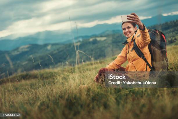 Joyful Nice Woman Making Selfies From The Mountain Hill Stock Photo - Download Image Now