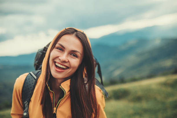 istock Delighted young woman standing in the mountains 1098333400