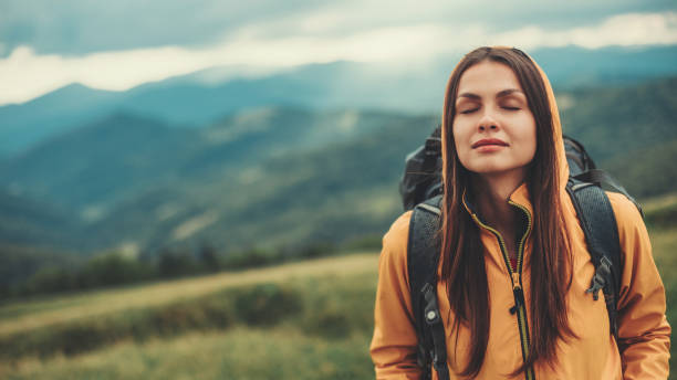 istock Relaxed beautiful woman standing in the mountains 1098333412