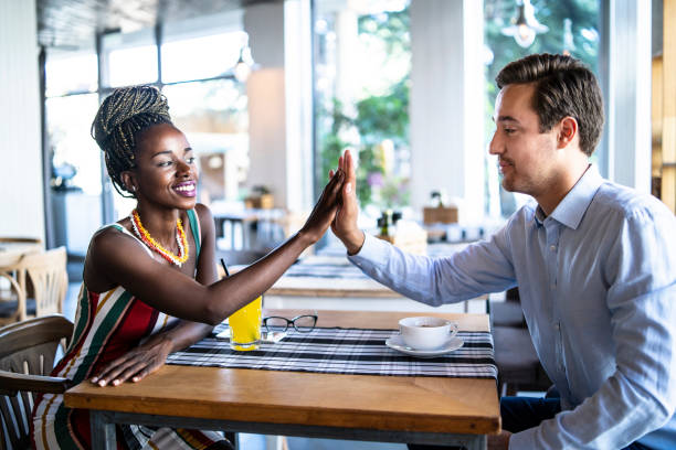 istock Couple in cafeteria, high five 1098333738