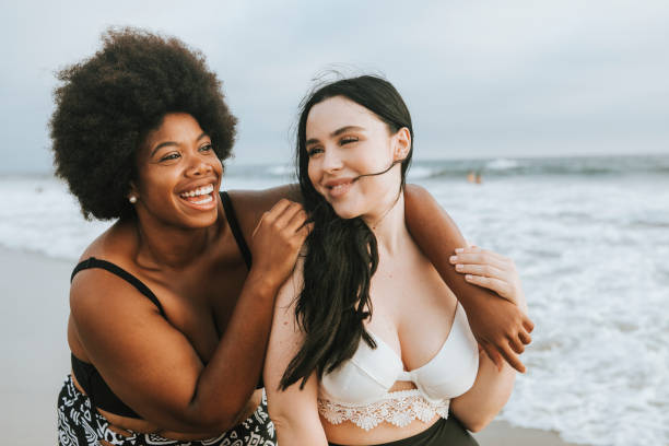 istock Cheerful beautiful plus size women at the beach 1098334070