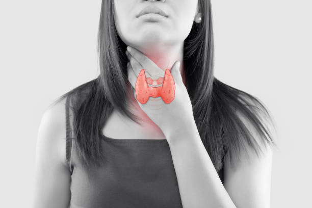The illustration of the thyroid is on the woman throat. The illustration of the thyroid is on the woman throat, Human thyroid gland control. Sore throat of a people against a gray background. The concept of healthcare and medicine. lymphoma photos stock pictures, royalty-free photos & images