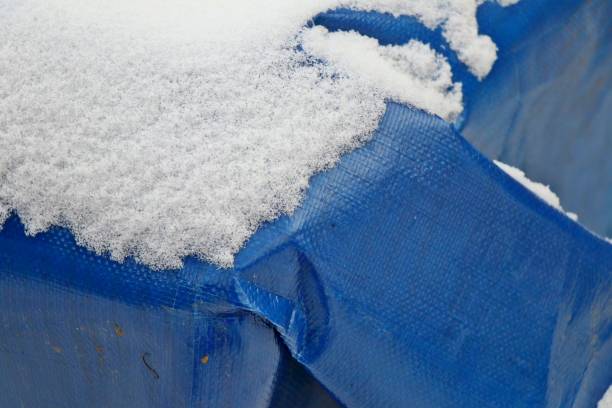 Snow covered blue tarpaulin.