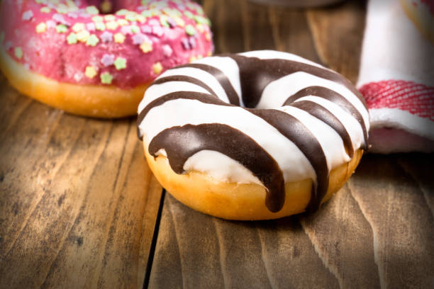istock Sweet, delicious American donut, donut on rustic table close up 1098338922