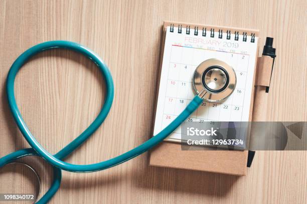 Top View Of Stethoscope On Calendar For Health Checkup Concept Annual Doctor Appointment For Physical Checkup Against Wooden Background Healthcare Medicine And Insurance Concept Stock Photo - Download Image Now