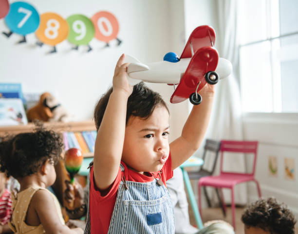 istock Preschooler enjoying playing with his airplane toy 1098340242